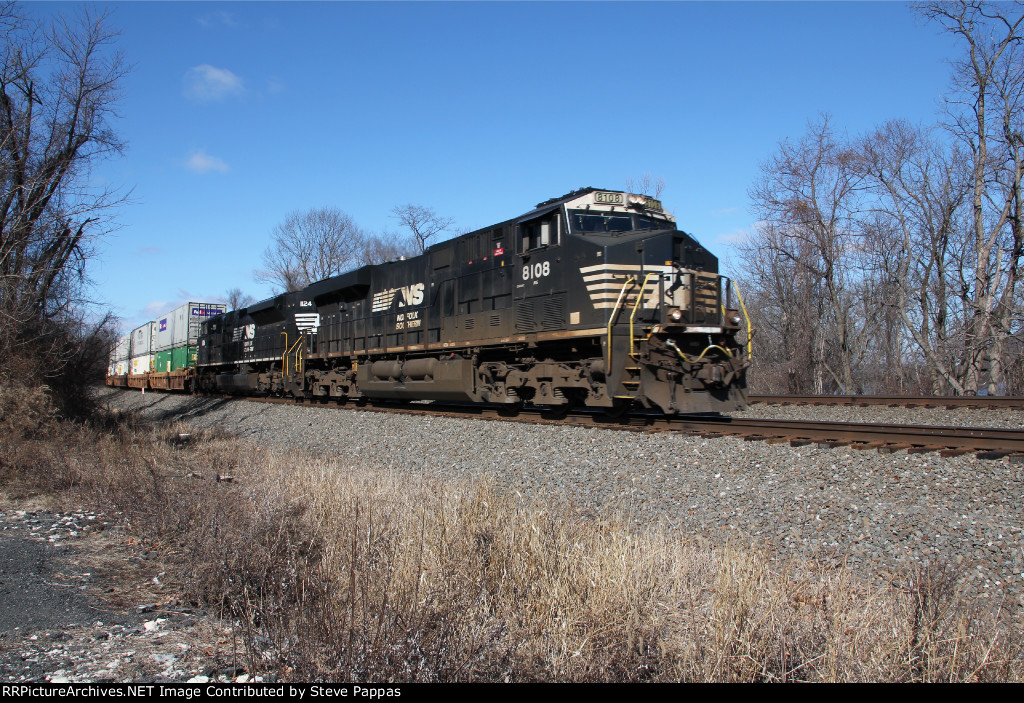 NS 8108 and 1124 lead a stack train down the siding at MP 116